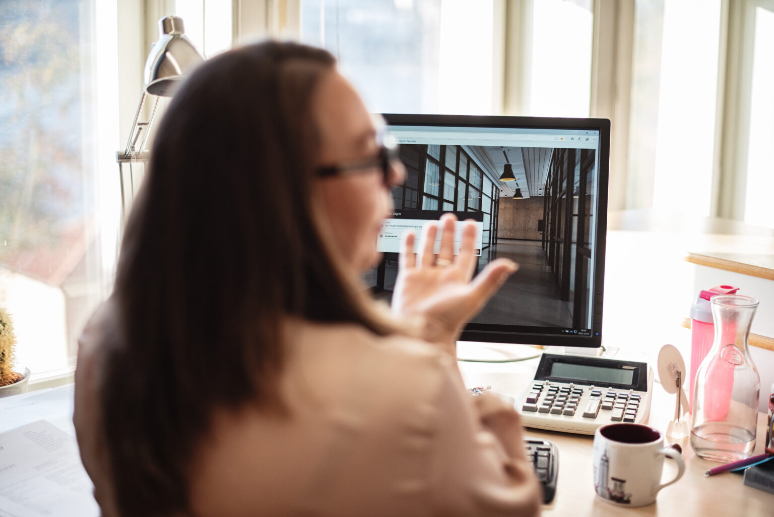 Operator at a desk managing access permissions on a computer screen